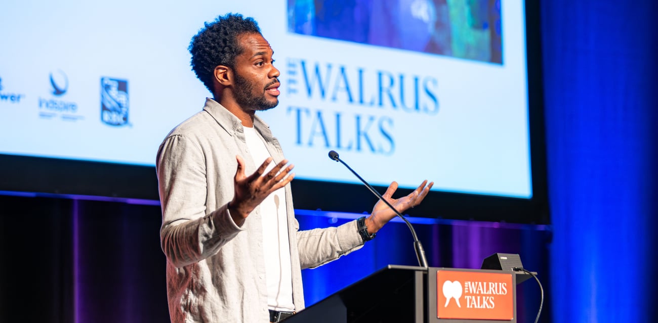 Anthony Morgan speaks at a podium at The Walrus Talks