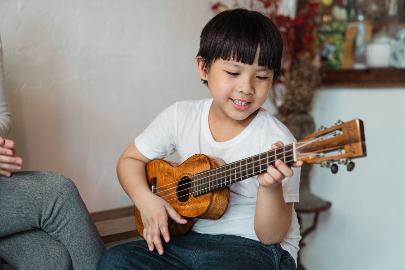 a child playing the guitar a child playing the guitar