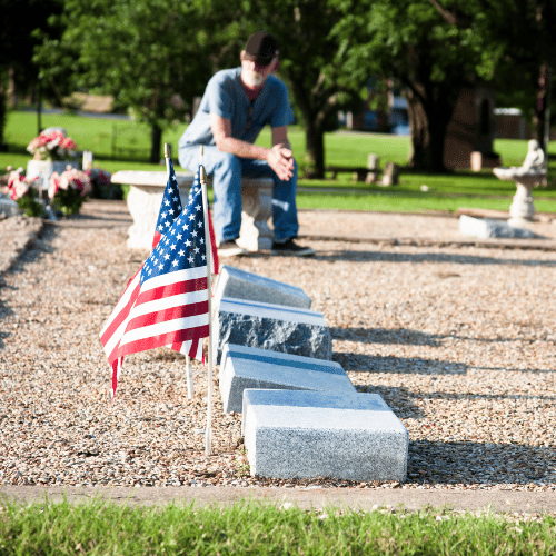 Headstones with American flags next to each one