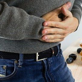 Person with both hands on their lower stomach
