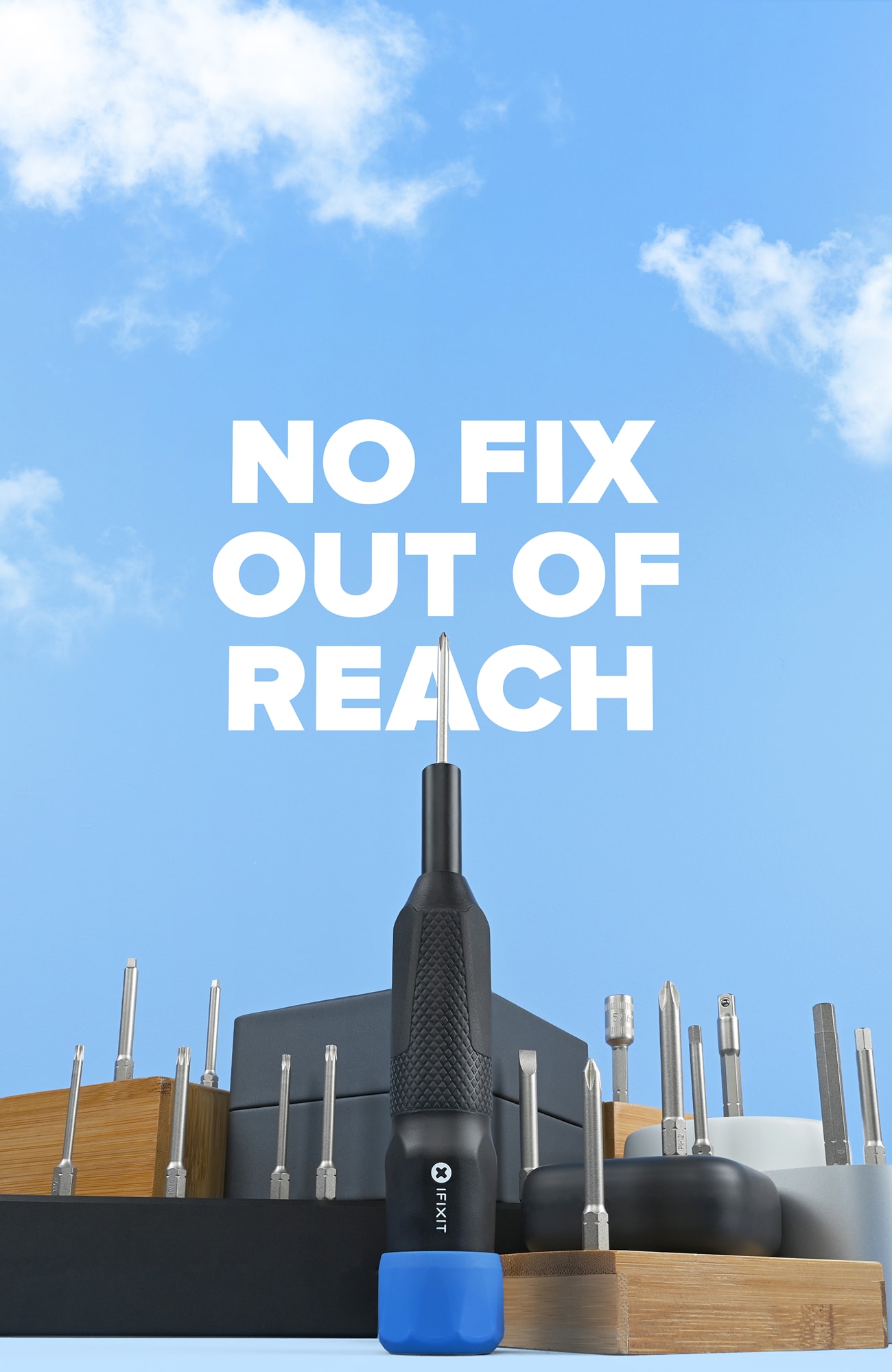 Product hero image showing the new iFixit Megalodon screwdriver standing upright among neatly arranged driver bits, set against a blue sky background with the headline “No Fix Out of Reach.”