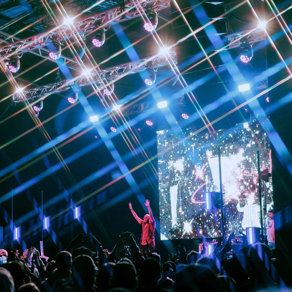 Yasiin Bey raises up his arms to the crowd at PICA