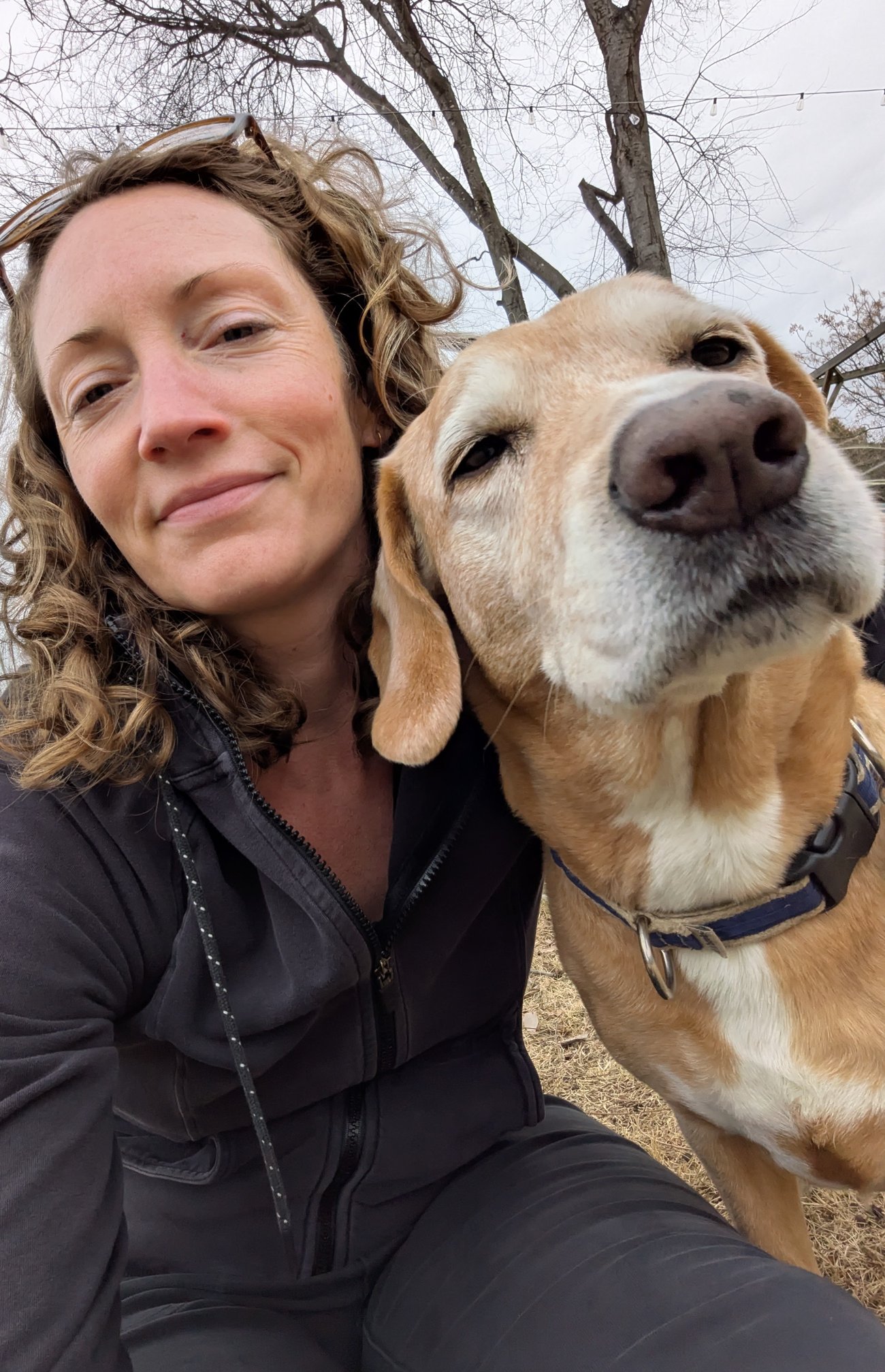 Abby taking a selfie with her dog outdoors.
