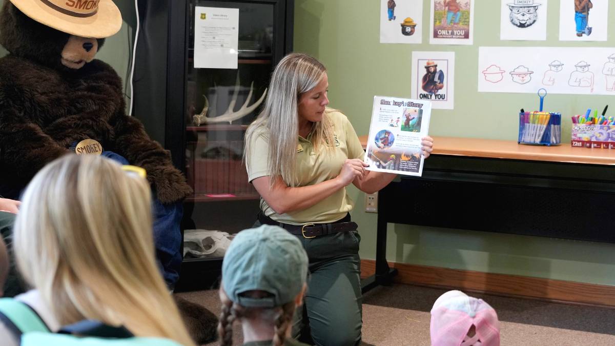 Caption: Emily Harvey, former natural resource education specialist at Midewin National Tallgrass Prairie, teaching youngsters about wildfire prevention. (Credit: U.S. Forest Service) 