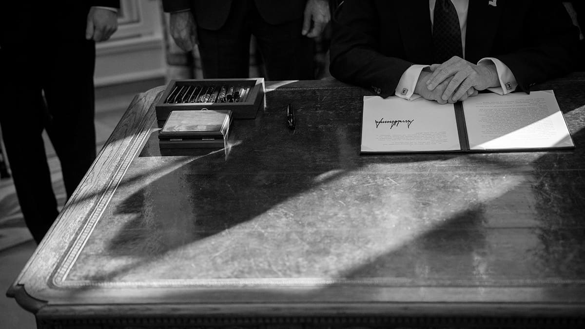 Black and white photo of President Trumps desk with an executive order that has just been signed Black and white photo of President Trumps desk with an executive order that has just been signed