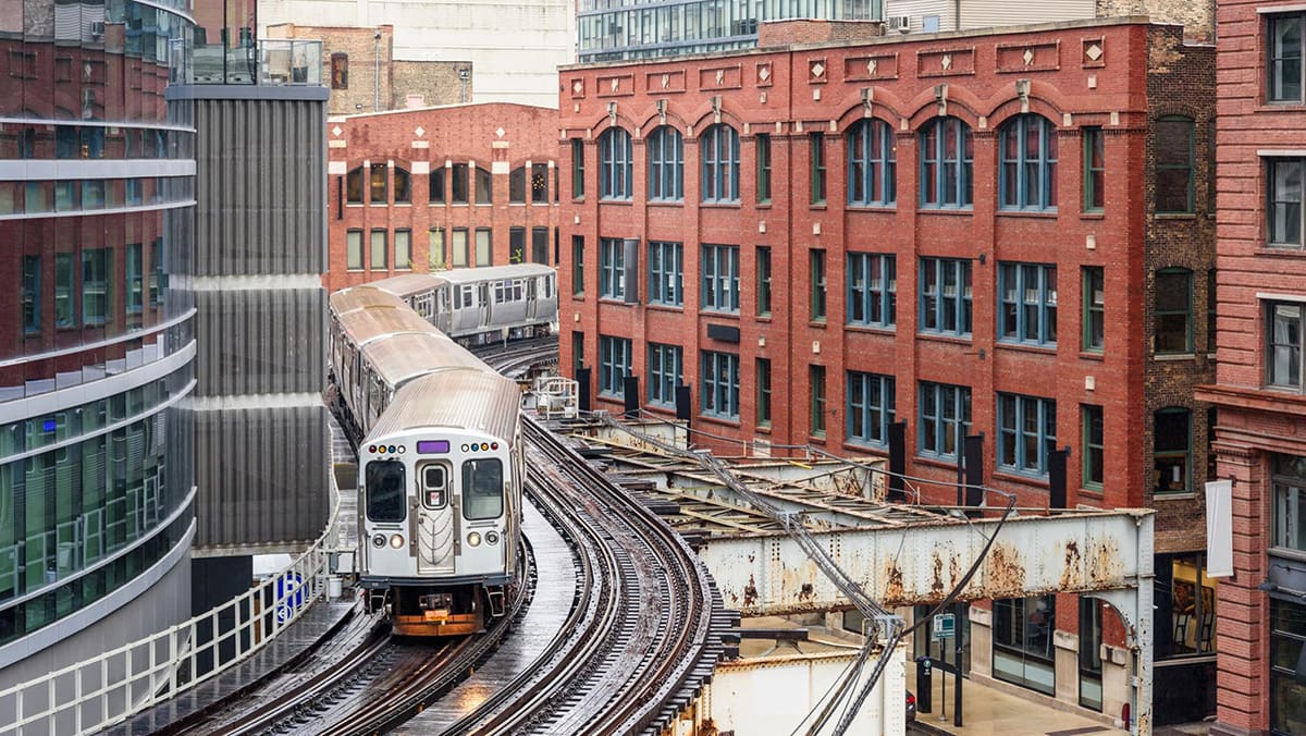 CTA 'L' train passing buildings in downtown Chicago CTA 'L' train passing buildings in downtown Chicago