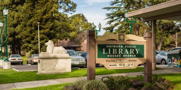 Photo of the Hayward Public Library Weekes Branch sign out front.