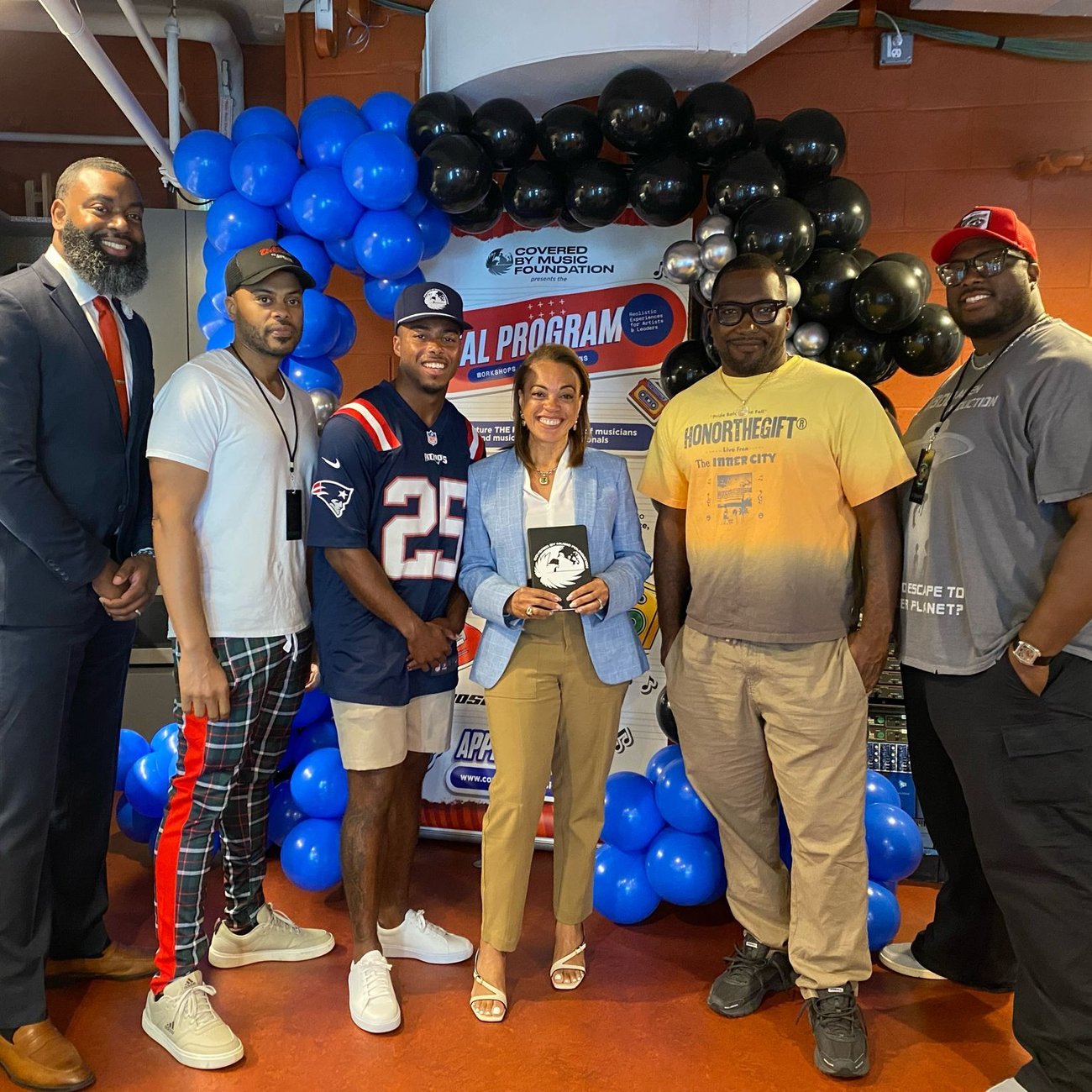 Marcus Jones, Kirjuan Freeman, and Keithen Foster pose among others at community event