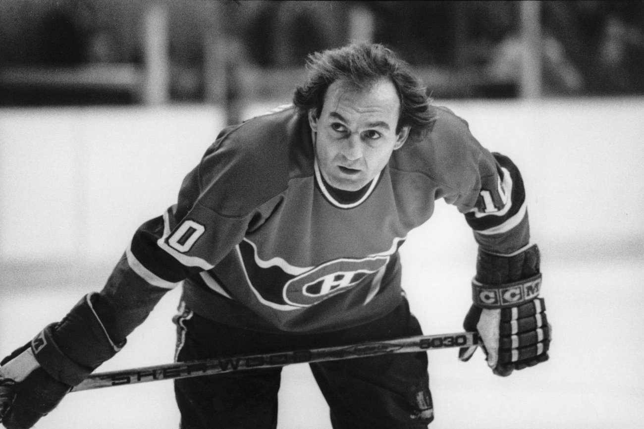 Black and white photo shows a hockey player on the rink