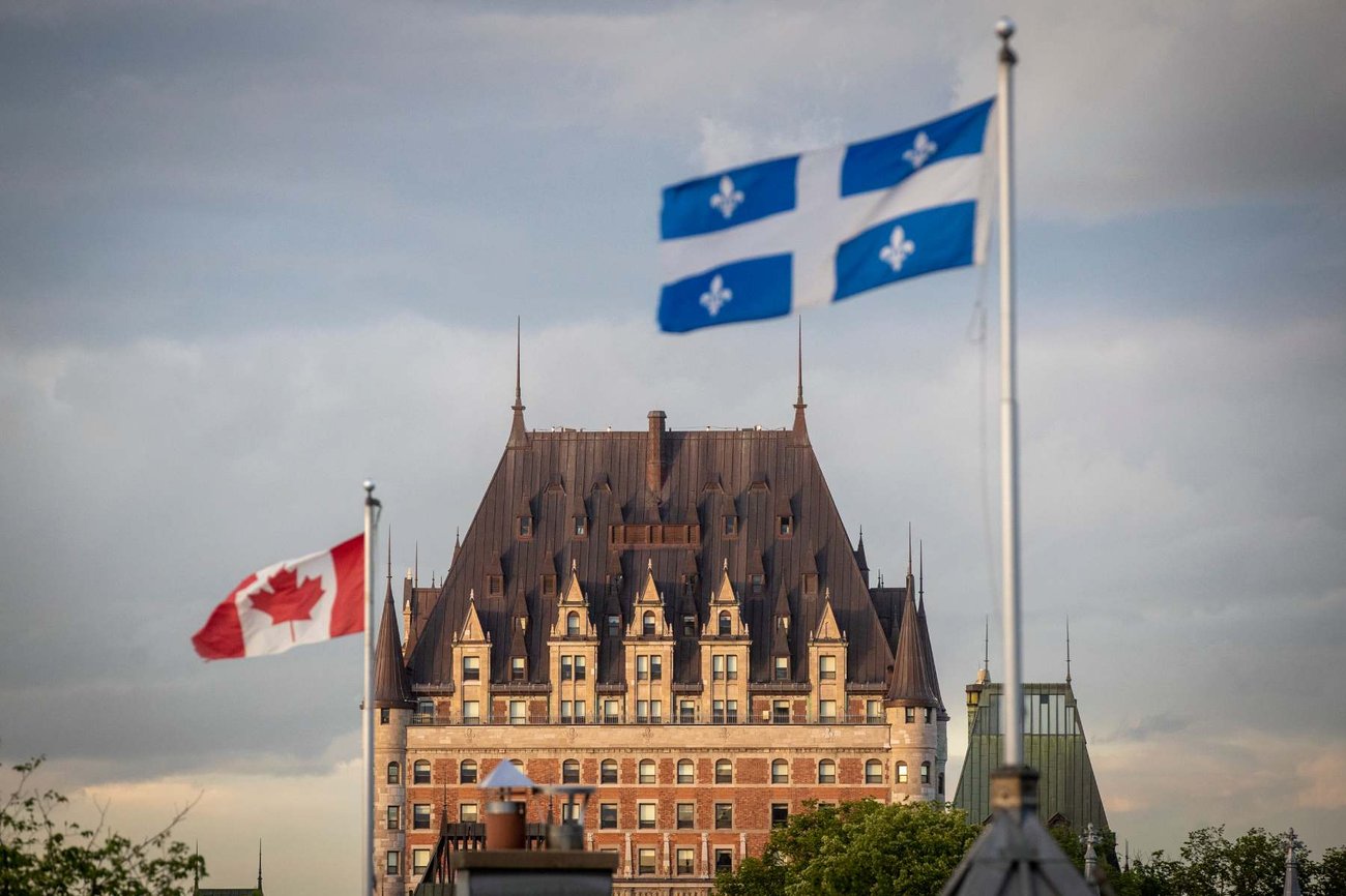 Photo of the Chateau Frontenac with waving Canadian and Quebec provincial flags