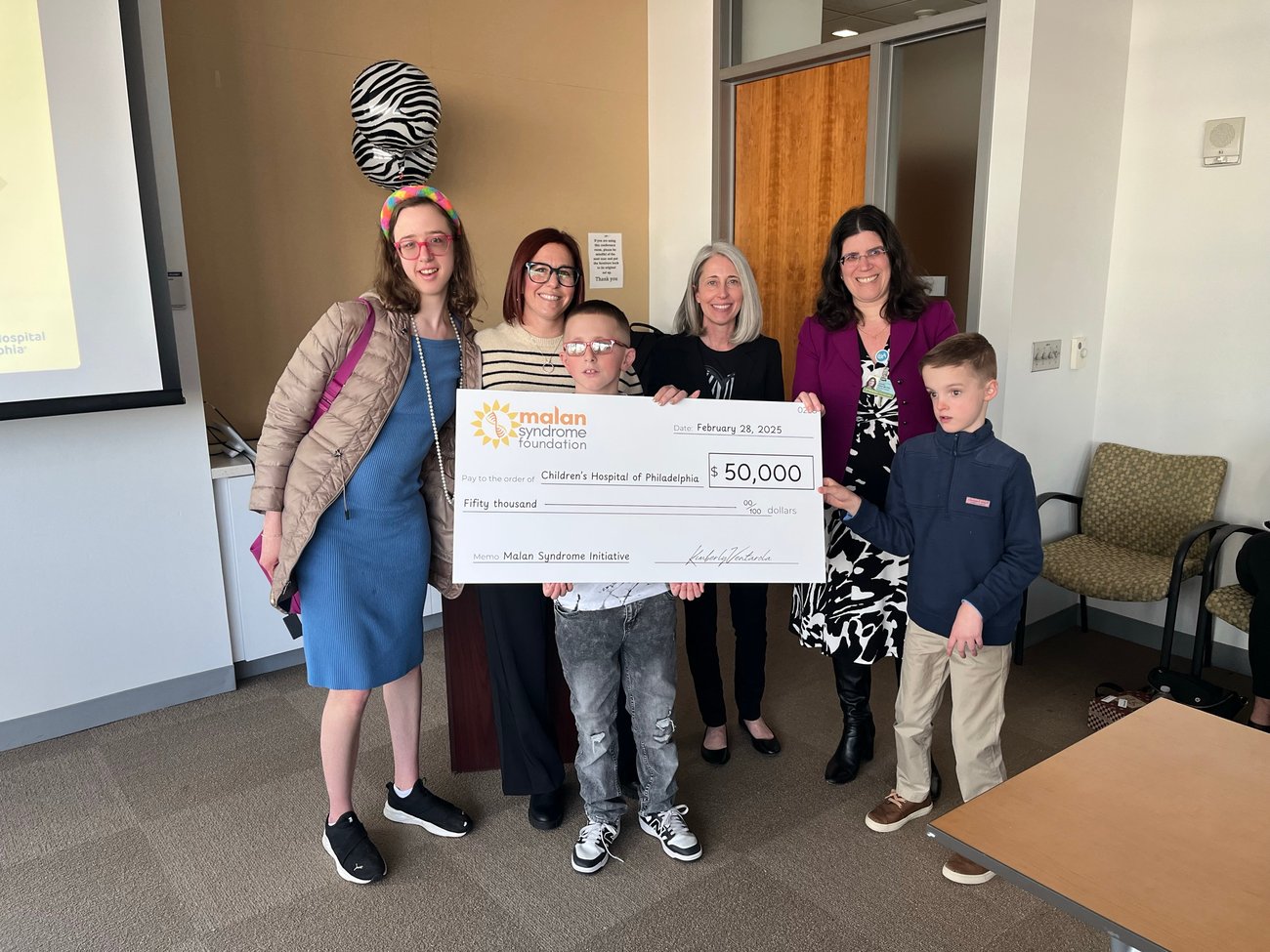 Photo of advocates holding a very large check
