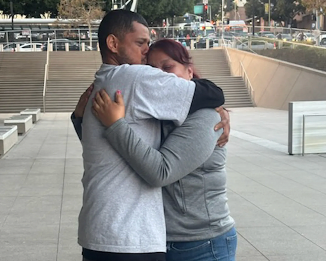 Dennis Quiñonez, a 32-year-old U.S. citizen, is seen embracing his mother shortly after his release on Thursday, Nov. 6, 2025. (Photo courtesy of The Immigrant Defenders Law Center)
