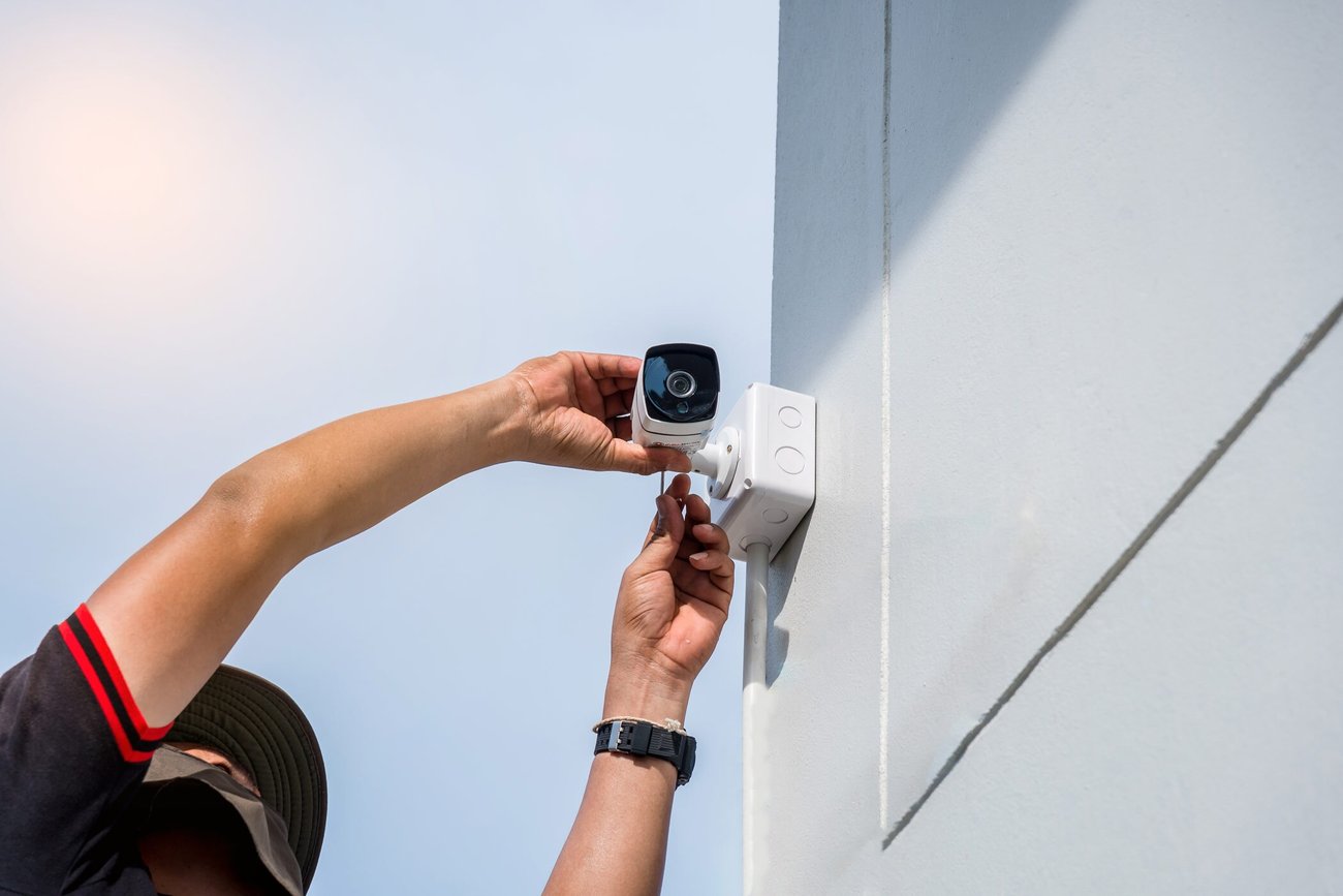 Employee setting up a security camera