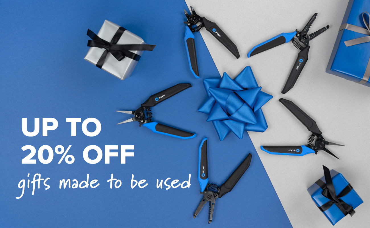 iFixit Mandibles pliers arranged radially around a blue gift bow, with wrapped presents placed on a split blue-and-grey background and promotional text on the left.