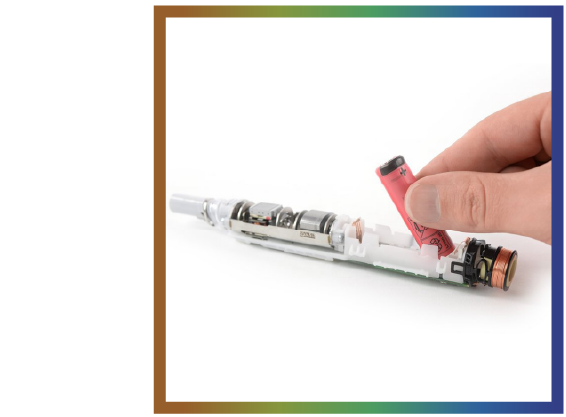 Hand inserting a small cylindrical battery into an opened Oral-B iO.