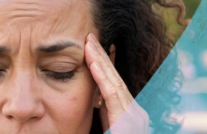 Woman holding her temple as she suffers from a migraine