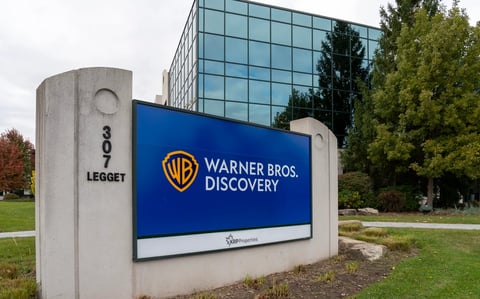 A large sign outside of a Warner Bros. Discovery building