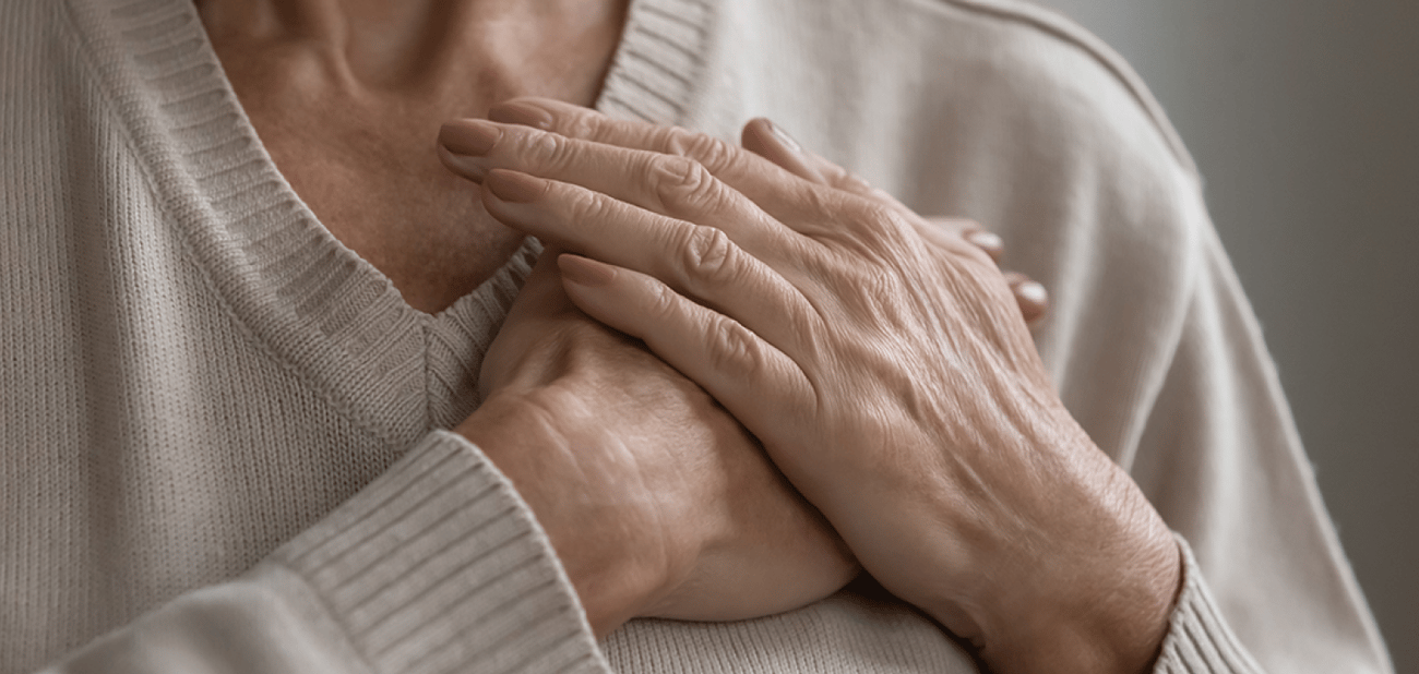 Photo of someone holding their hands over their heart