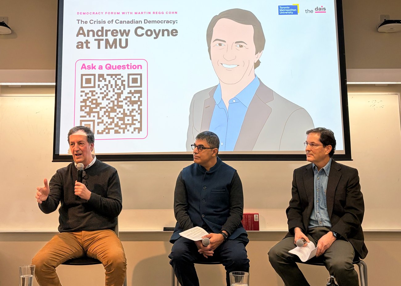 A photo of three men seated in conversation
