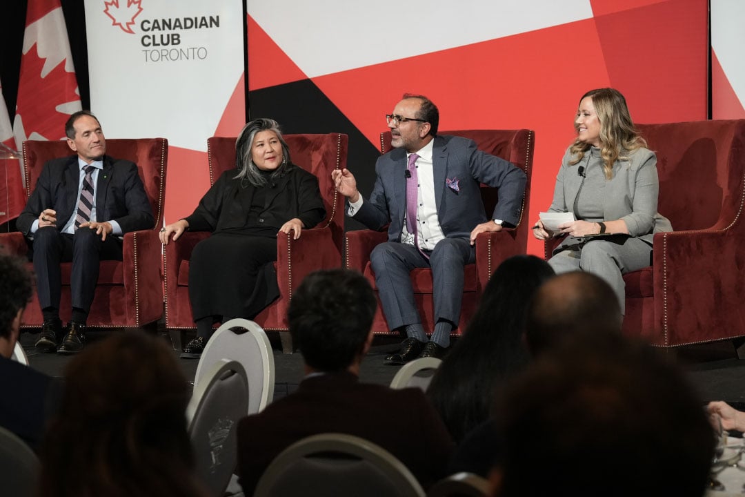 A photo of two men and two women seated onstage in conversation