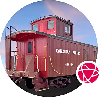 A red Canadian Pacific caboose against a blue sky.