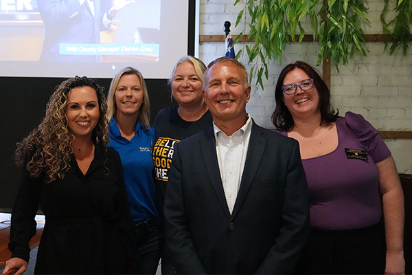 Photo of County Manager Darren Gray along with members of the community