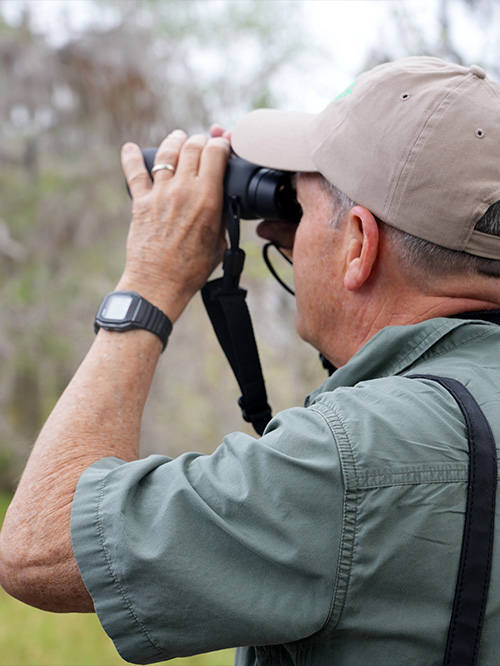 Man looking through binoculars