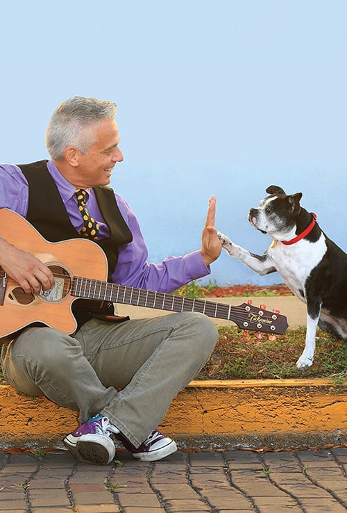 Mr Richard high fiving a Boston Terrier