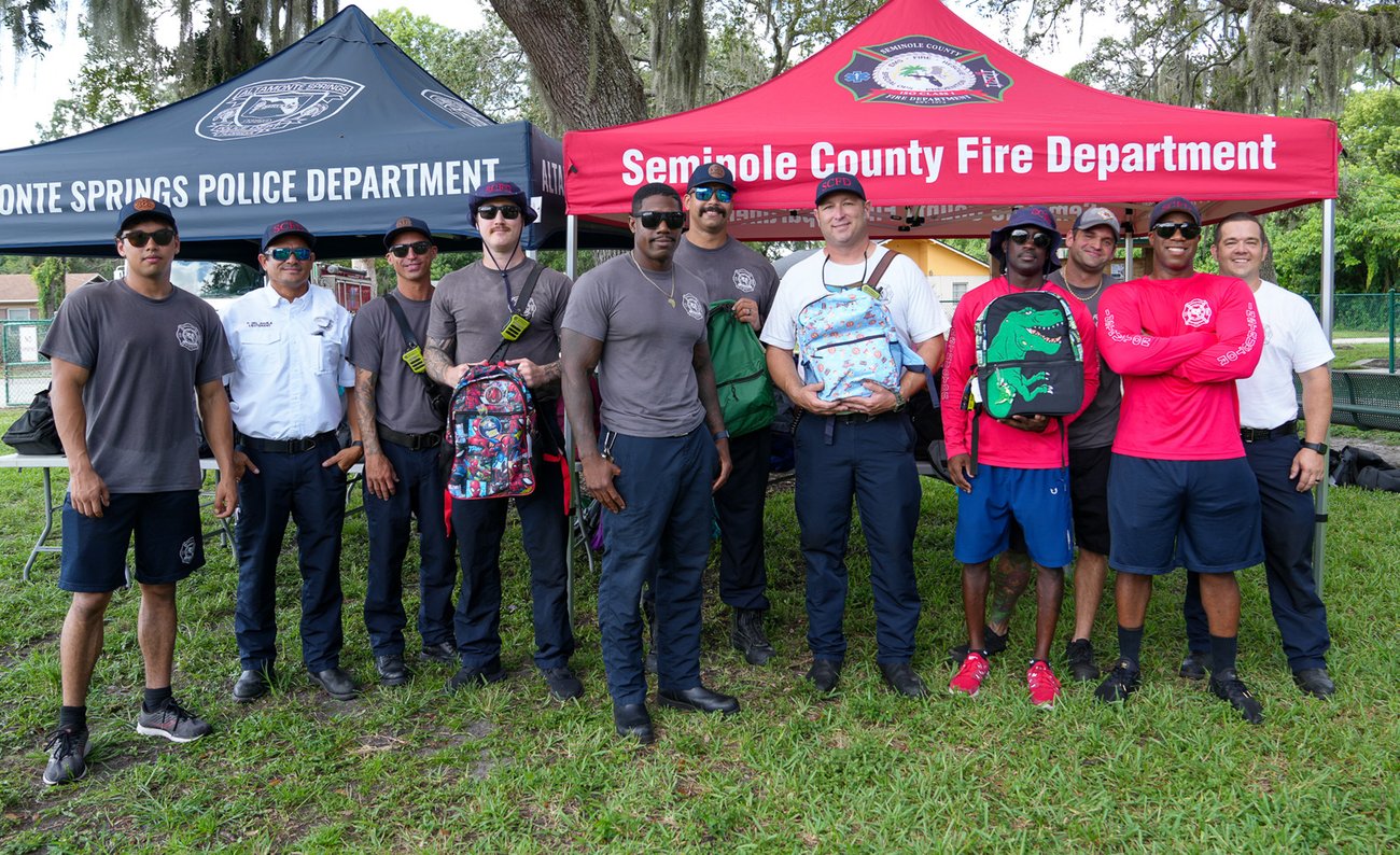Firefighters standing with Donated School Supplies