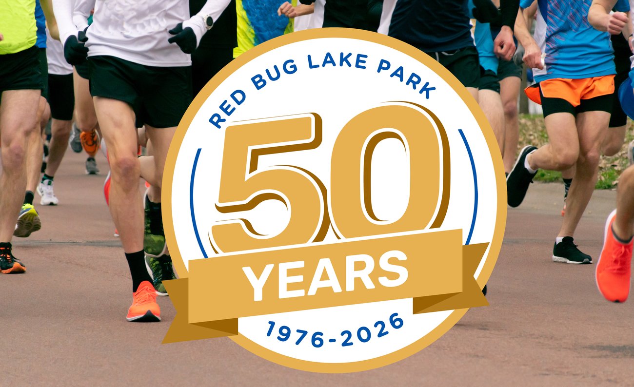 Red Bug Lake 50th logo in front of runners Red Bug Lake 50th logo in front of runners