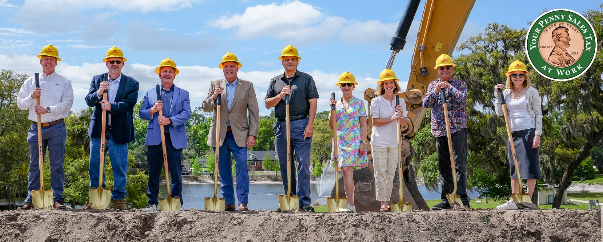 Seminole County Commissioners and leadership wearing hard hats and holding gold shovels at construction site Seminole County Commissioners and leadership wearing hard hats and holding gold shovels at construction site