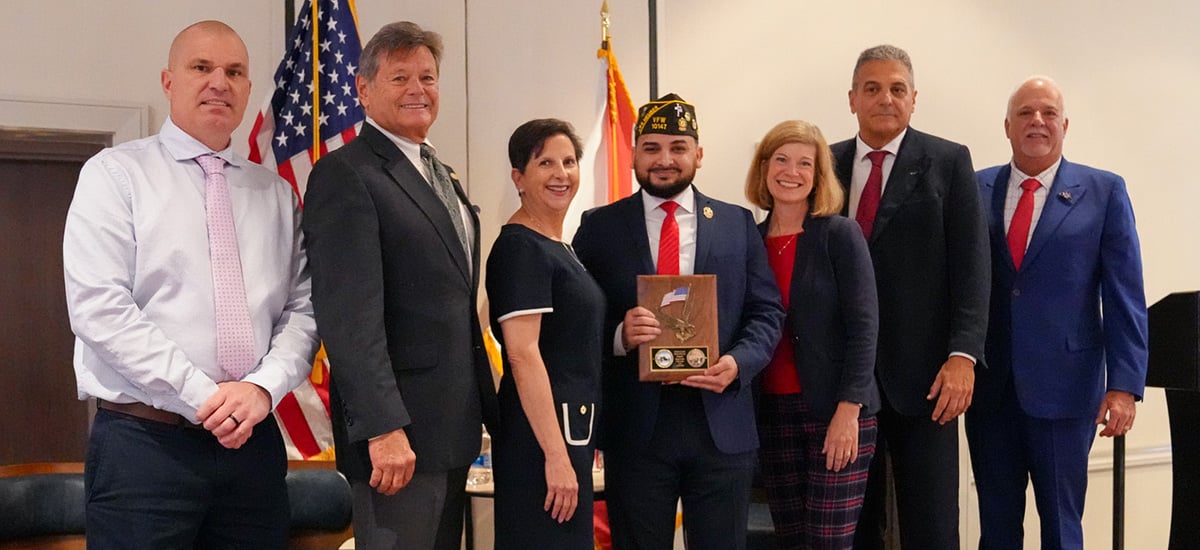 Veteran of the Year standing with Commissioners and Staff Veteran of the Year standing with Commissioners and Staff