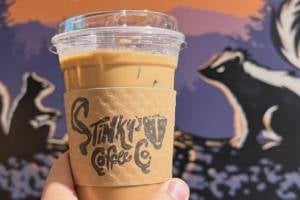 hand holds up stinky coffee cup