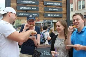four people eat wings at wing fest