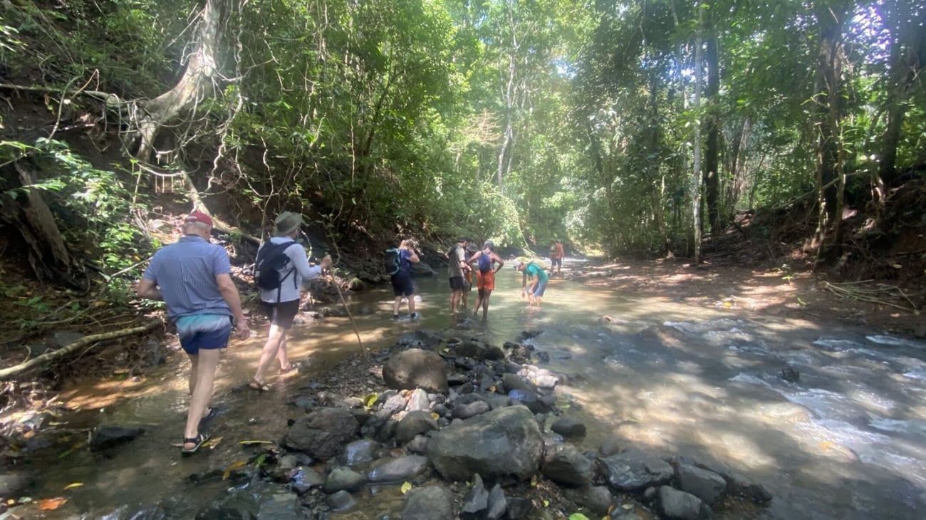hikers crossing the river