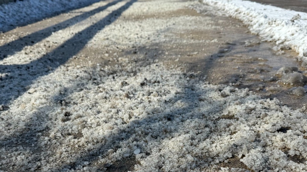 A sidewalk in Chicago is covered with salt. 