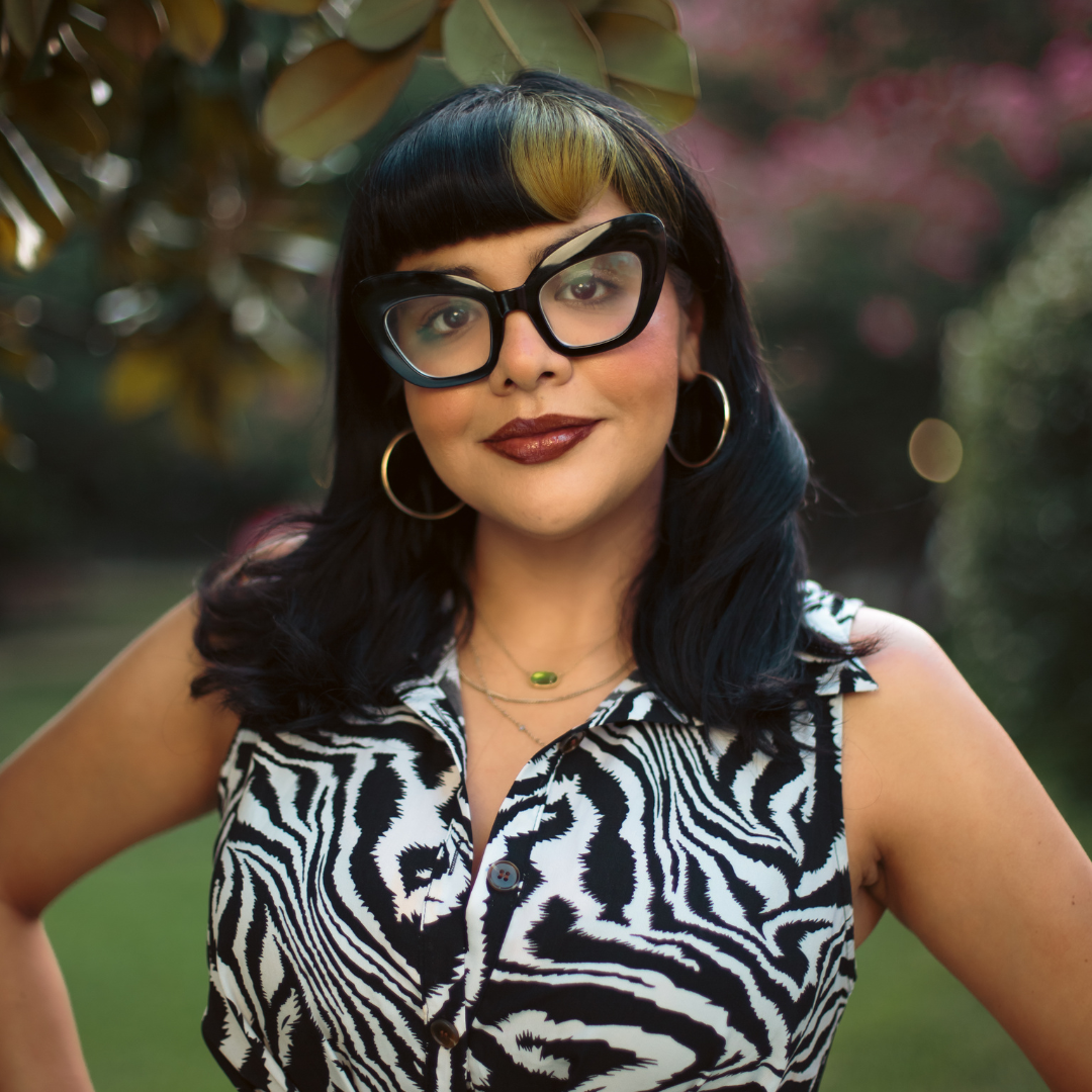A photo of Iris, wearing black glasses and looking at the camera.