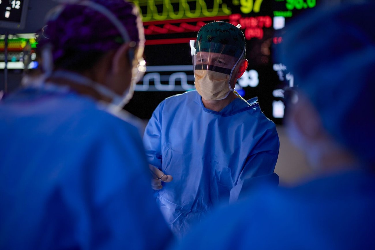 A female radiologist helps a woman get positioned for a mammogram.