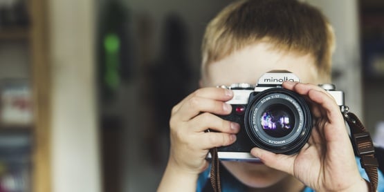 Image of a child using a camera to take a photo