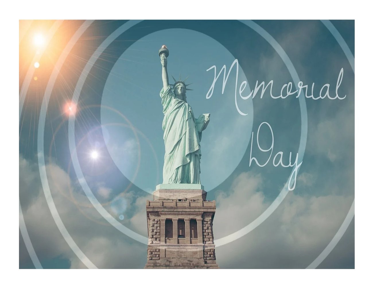 Statue of Liberty with the sun, blue sky and a few clouds, Memorial Day in cursive, white writing