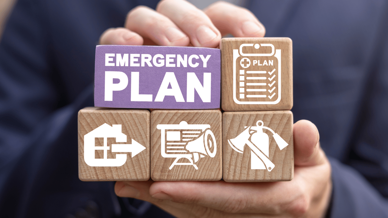 Header image of a hand holding blocks with emergency plan related icons on them