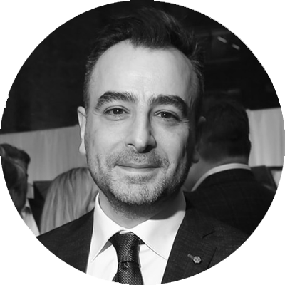 A black and white headshot of Carmine.