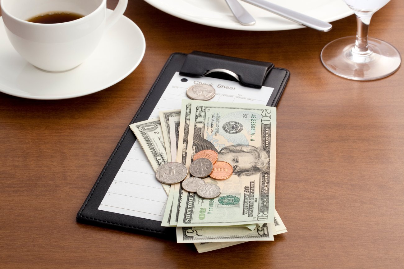 a restaurant bill wish cash and change on top of it.