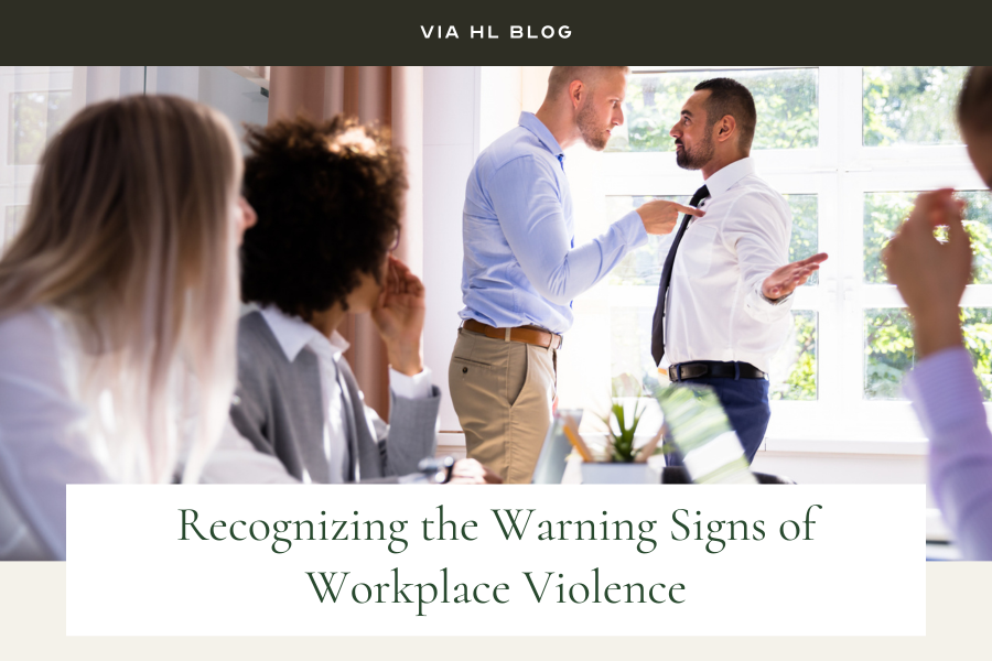 Via Hotel Management mage: person writing on clipboard at desk. Another person has their hands clasped waiting next to them. 
