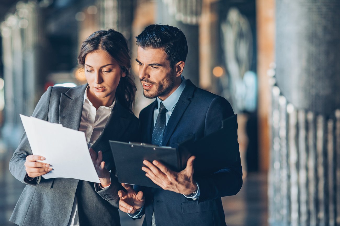 two coworkers reviewing papers