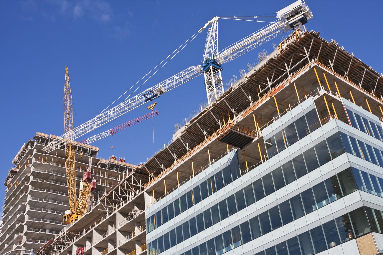 A construction site. Crane on top of unfinished building.