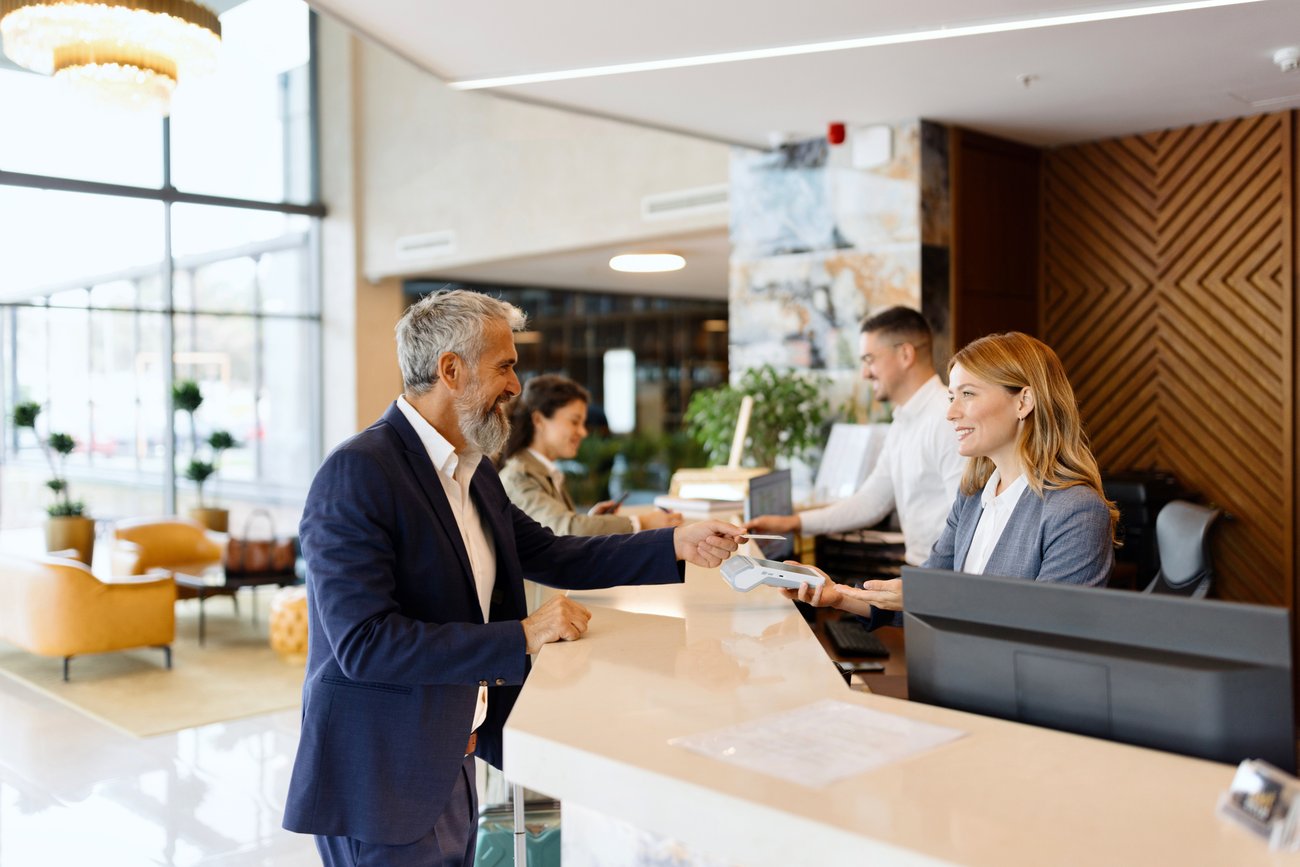 Man paying something with a credit card at the hotel reception
stock photo