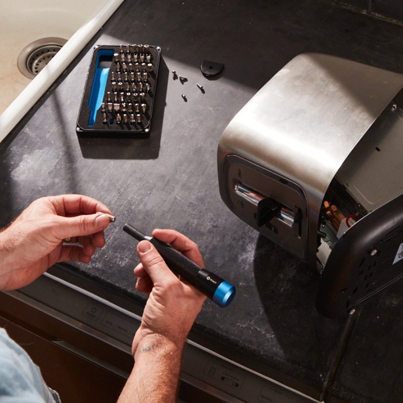 Fixer repairs a toaster with the Mahi Driver Kit