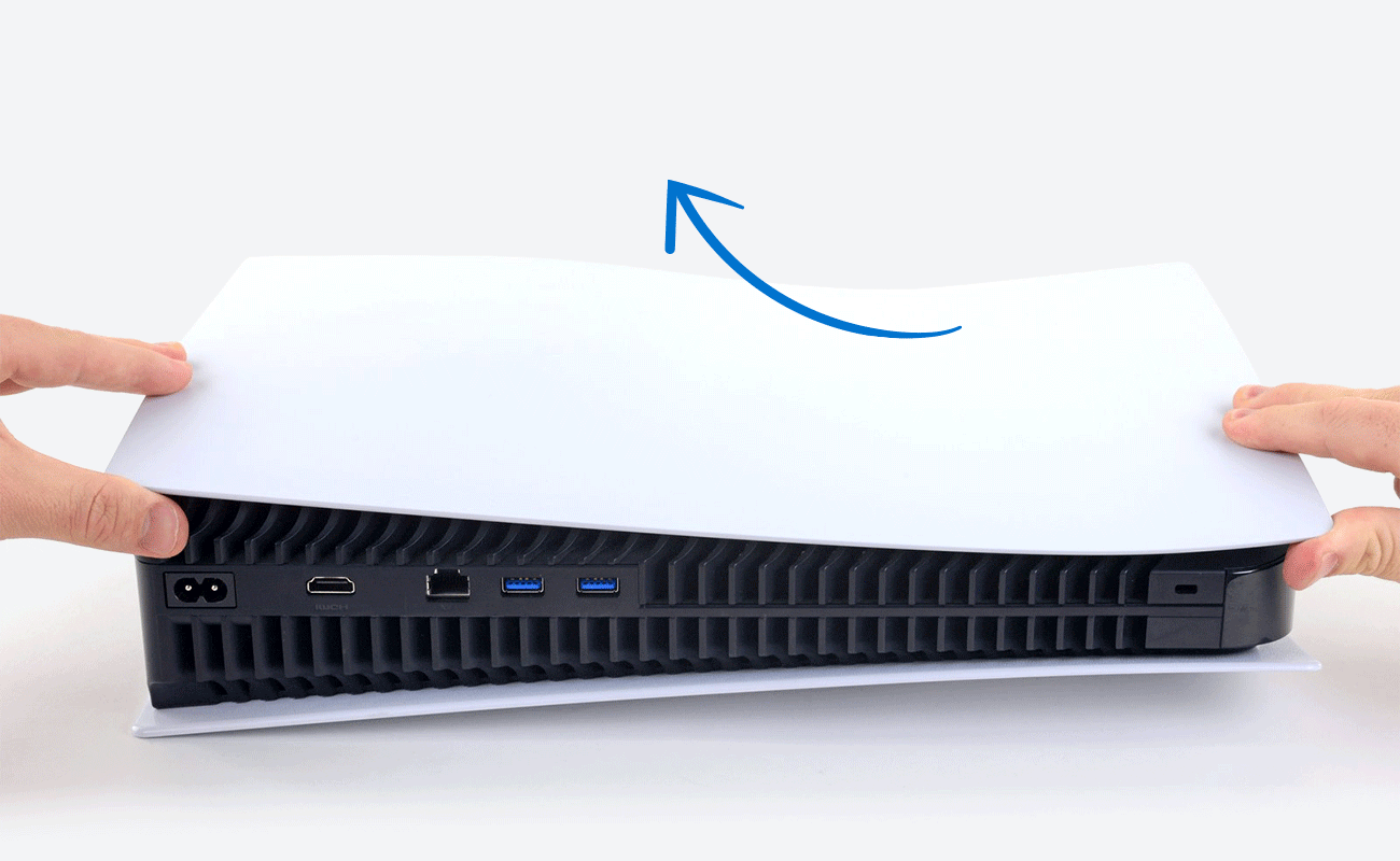 A pair of hands remove the faceplate from a PlayStation 5 console