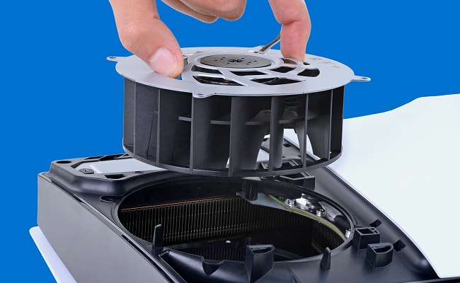 Hand removes the fan from a PlayStation 5 Pro
